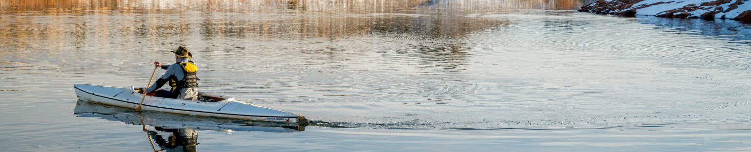 A man rowing a boat on a lake